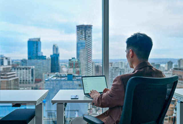 Business man using laptop in modern office